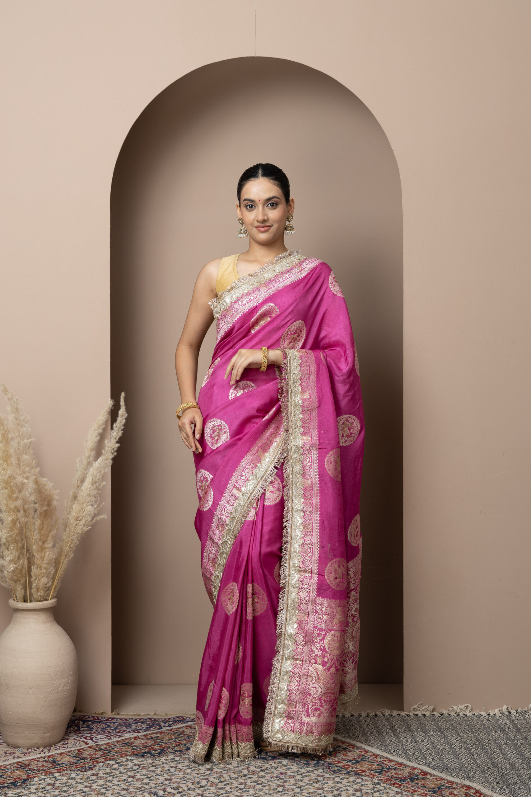 Vibrant Rani Pink with elegant gold zari detailing
